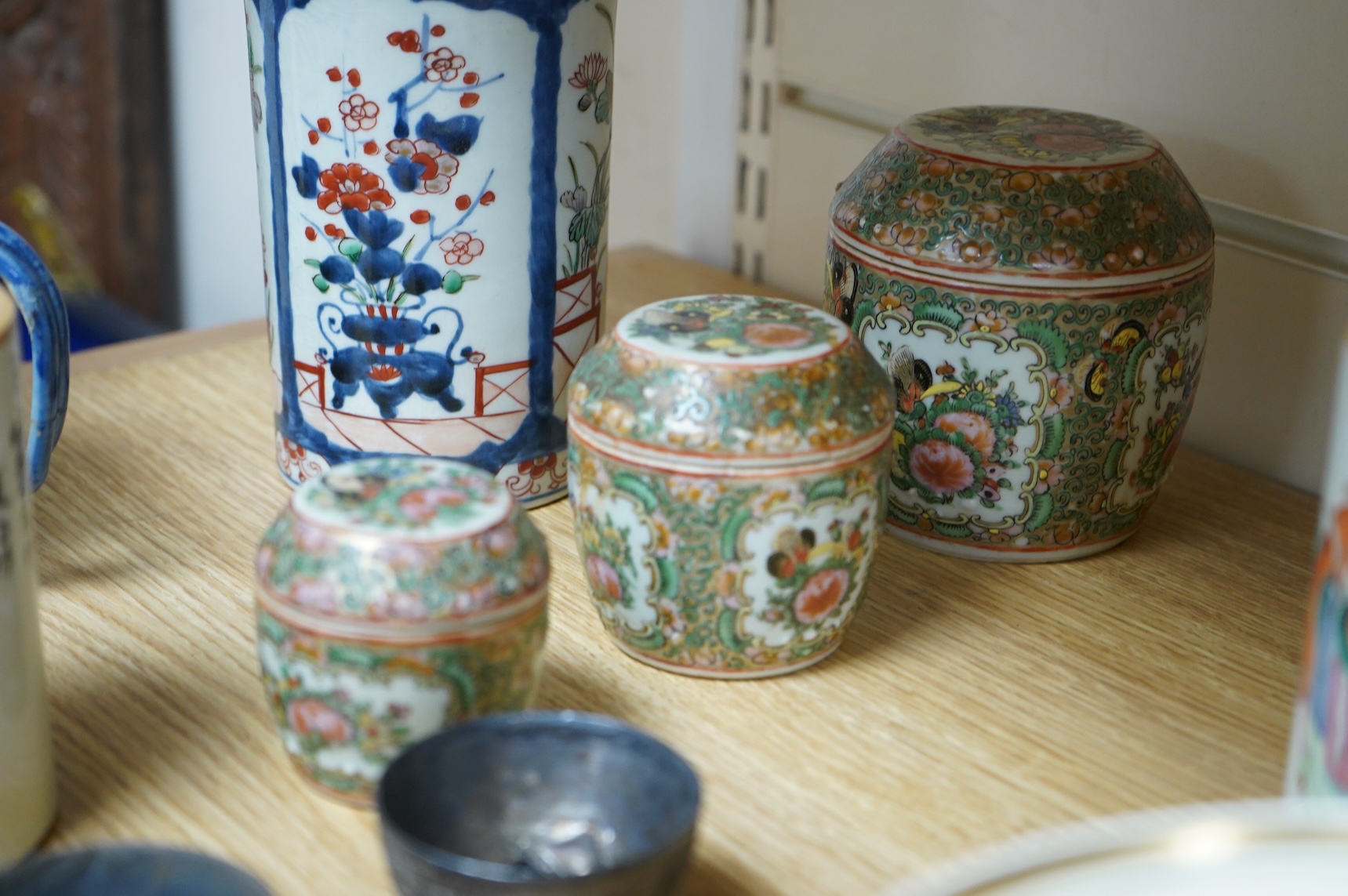 A collection of Chinese ceramics to include a blue and white mug, set of three graduated Canton jars and covers and two cylindrical brush washers
